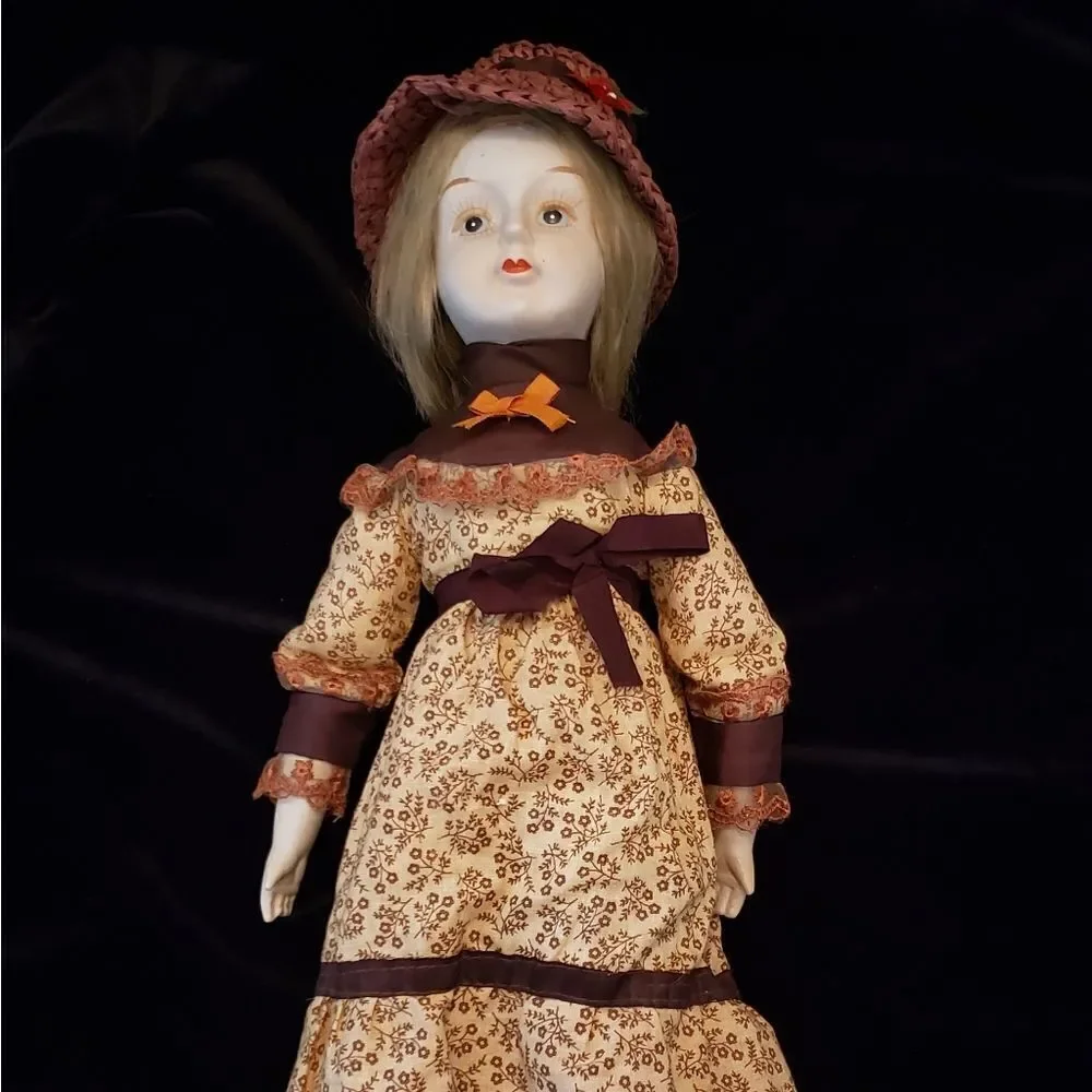 Vintage Porcelain Doll with Brown Dress and Hat